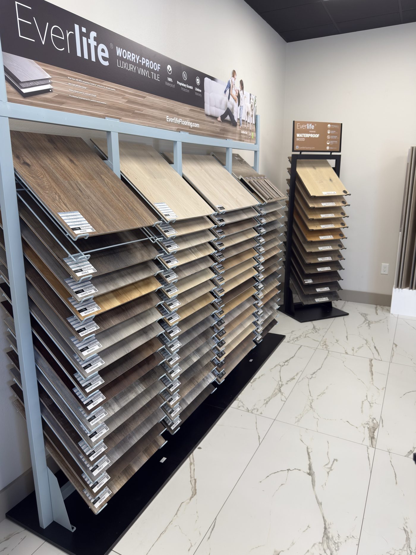 Flooring and tile samples laid out in the Quality By Design Kitchens showroom in Bradenton