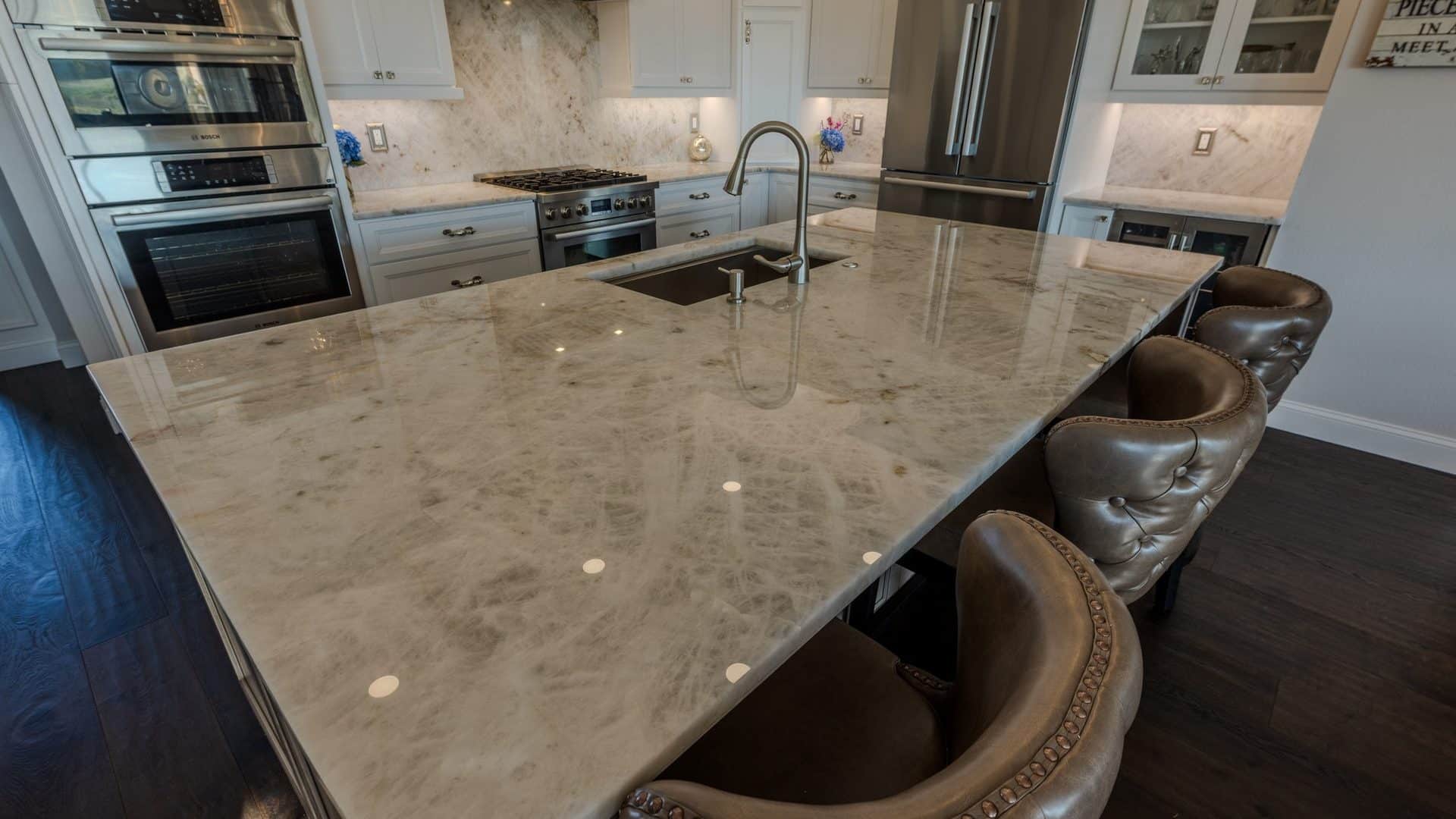 Kitchen tile floor meeting the living area flooring in an open-concept Bradenton home